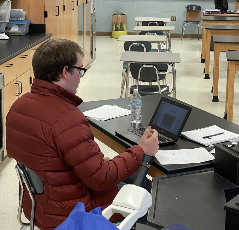 Student presenting his project in a science lab